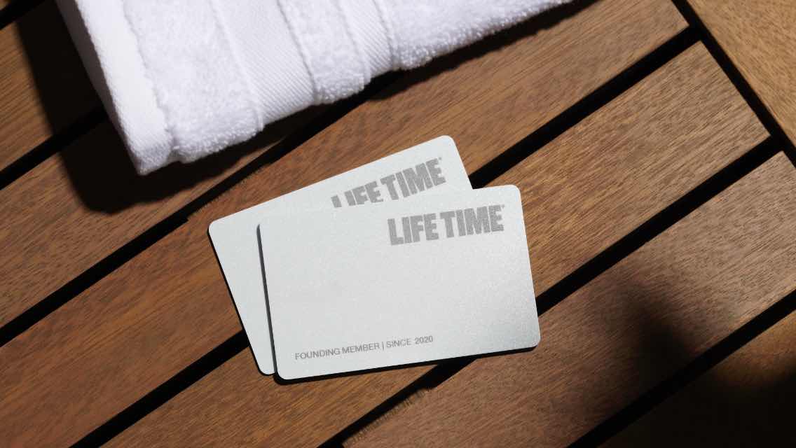 Two Life Time membership cards on a surface.