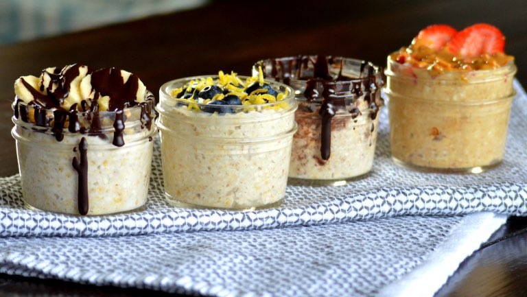 Four jars of overnight oats with various toppings.