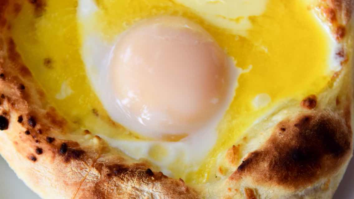 An over-easy cooked egg inside a piece of bread.