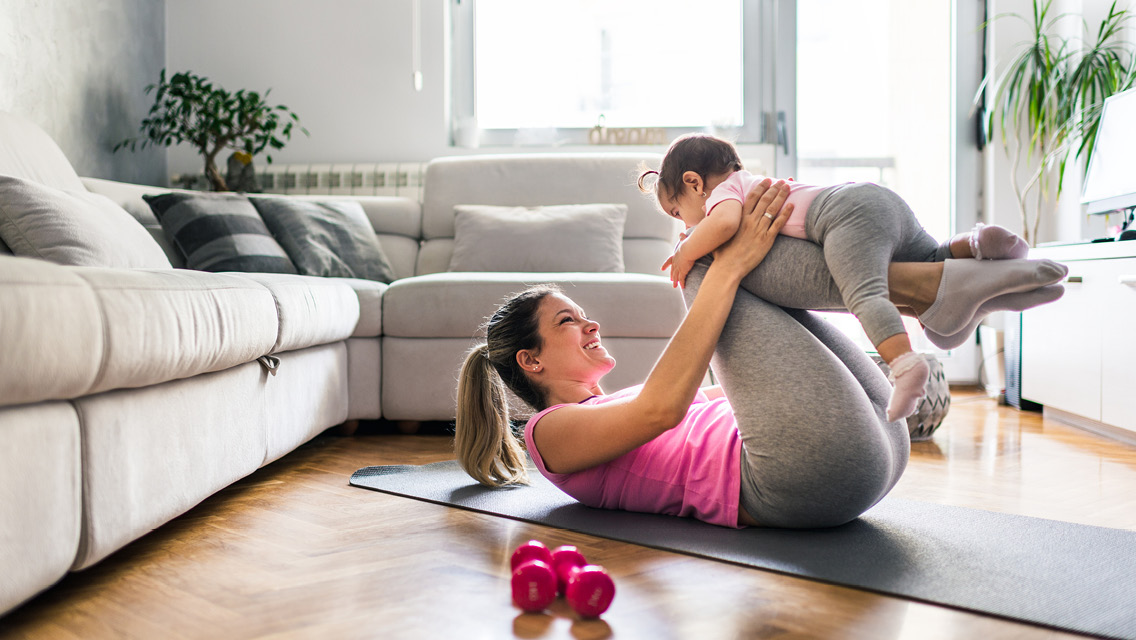 Mother and her baby at home exercising