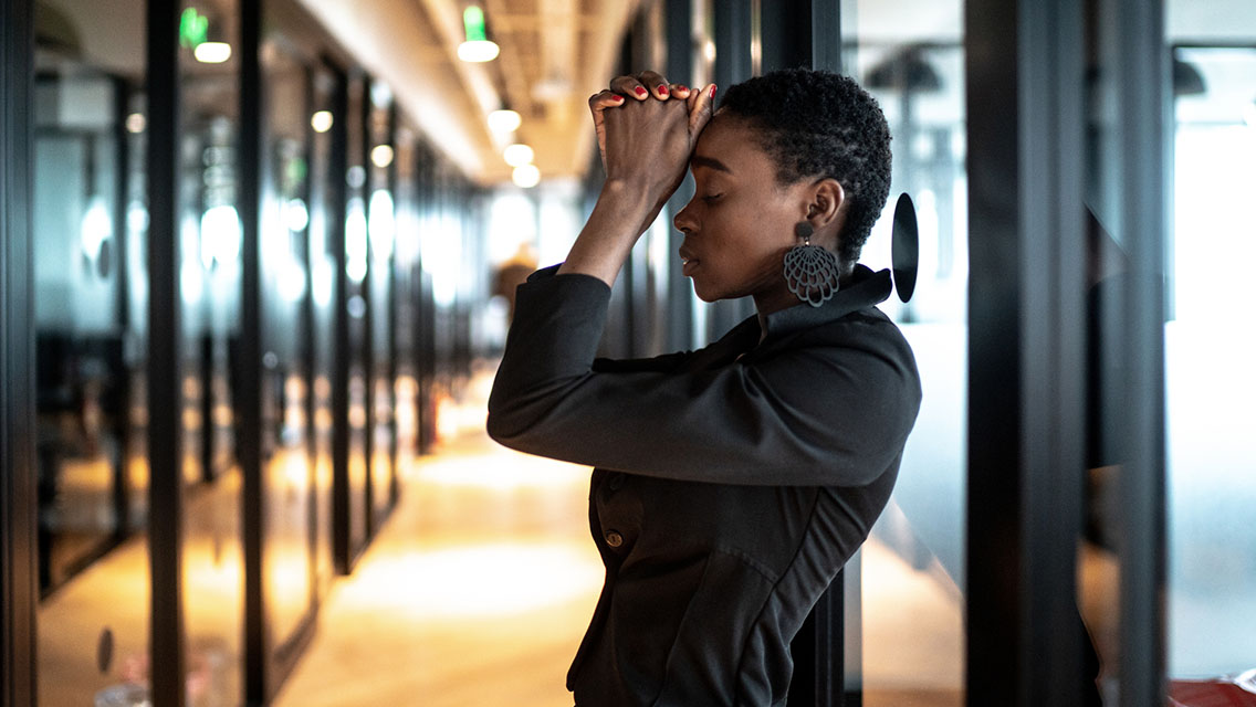Worried young business woman at corridor office