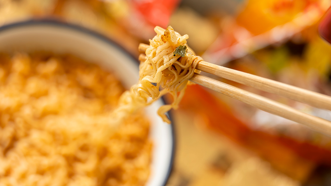 chopsticks hold ramen noodles