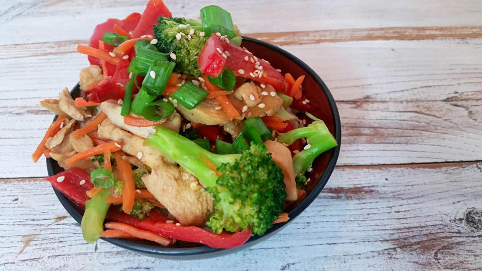a bowl of chicken vegetable stir fry