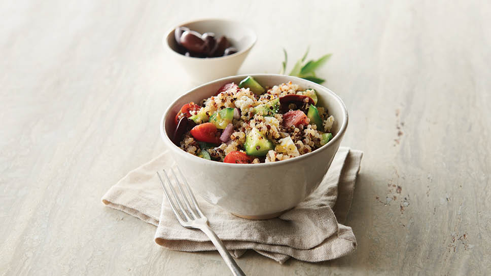 a bowl of greek quinoa salad