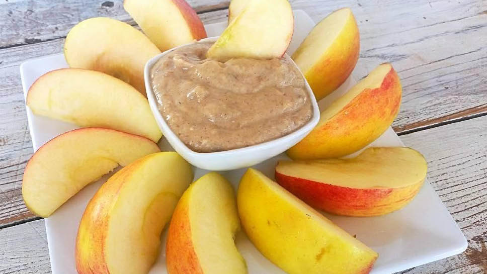 a bowl of apple pie fruit dip served with apple slices