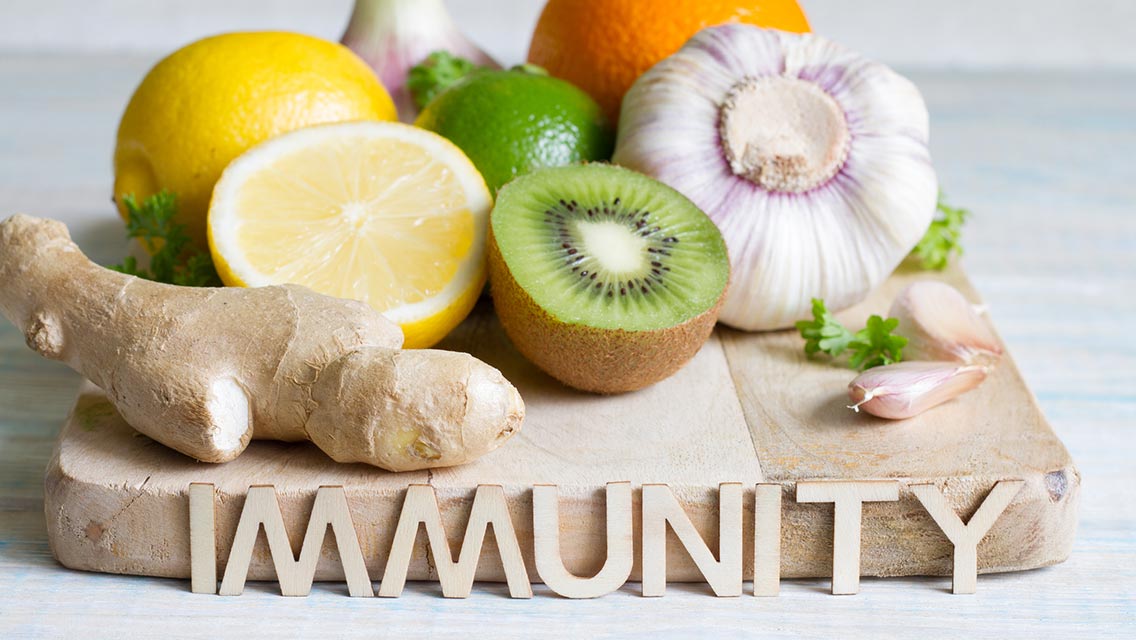 Cutting board of healthy foods with the word "immunity"