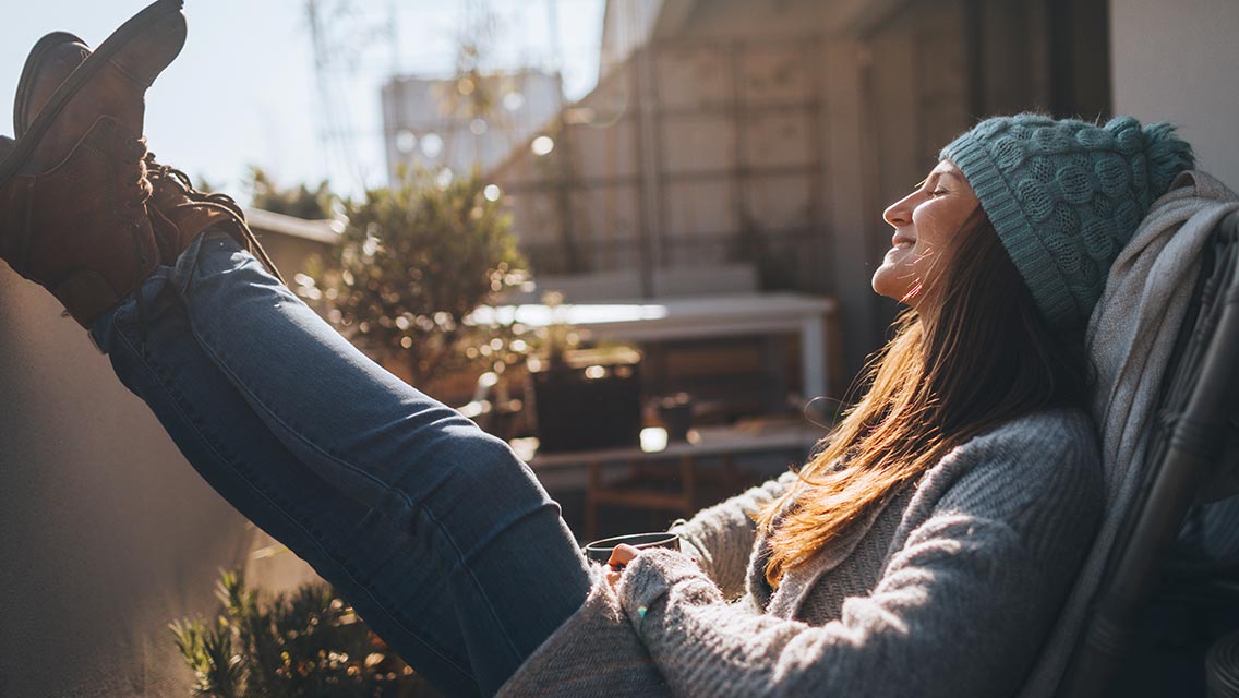 Woman relaxing on balcony