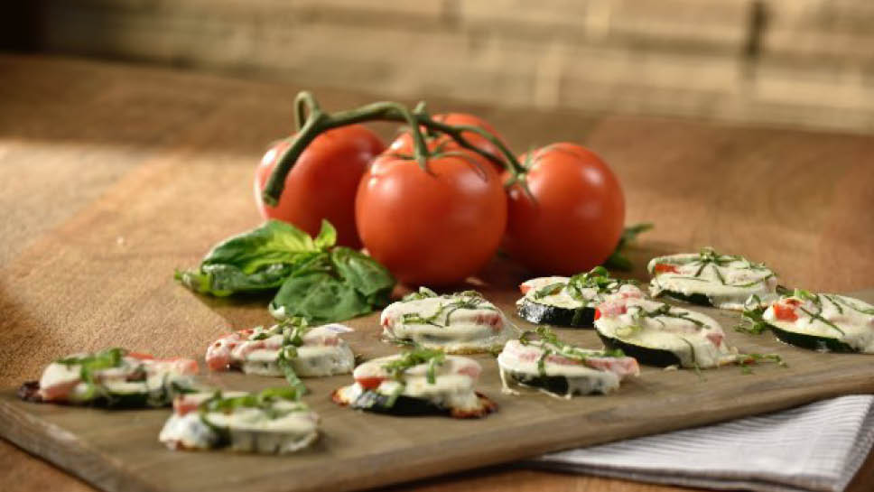 zucchini pizza bites served on a wooden tray