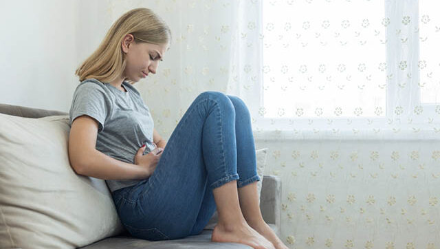 Woman holding stomach