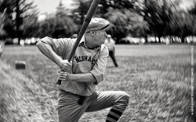 elderly man playing baseball