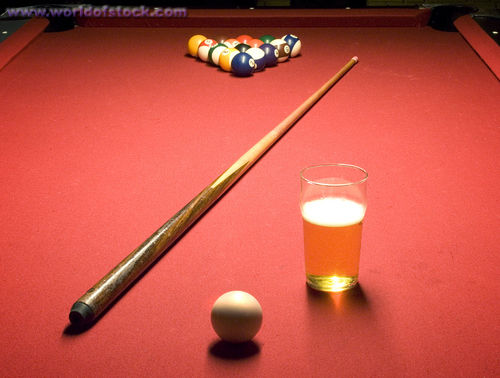 billiard tables with glass of beer
