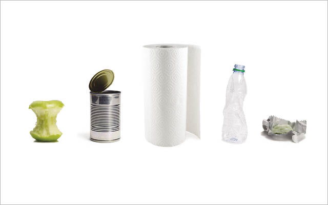 A selection of items, including an aluminum can, paper towels, and a plastic bottle