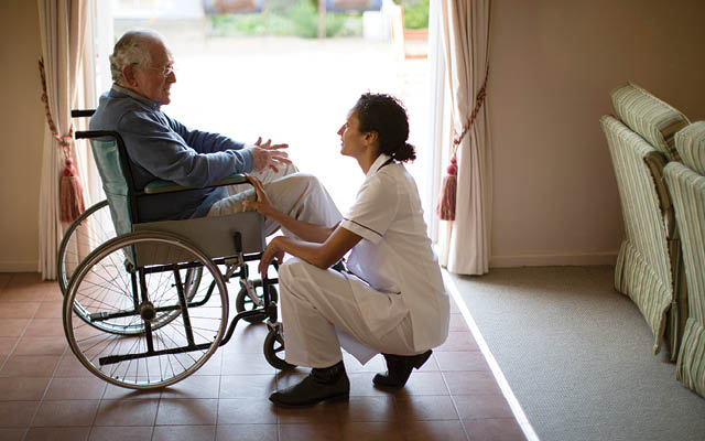 Nurse speaking with elderly patient