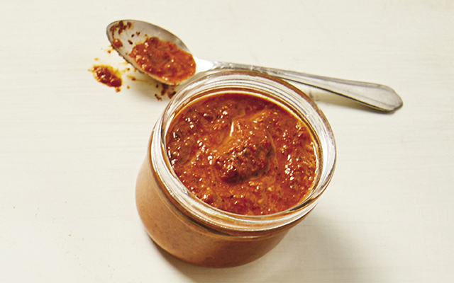 jar and spoon of chipotle red pepper drizzle