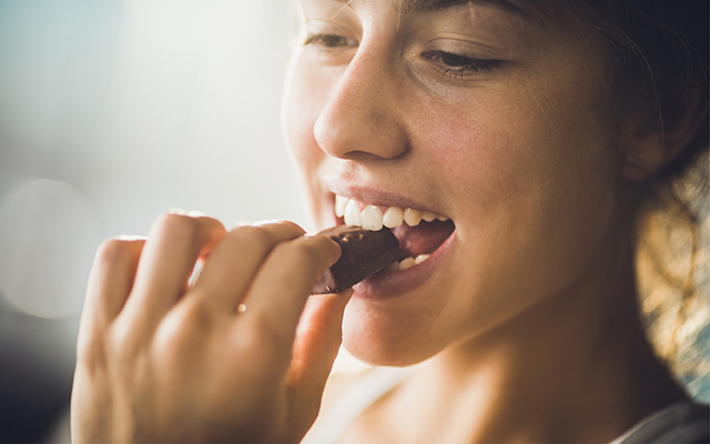 woman biting chocolate