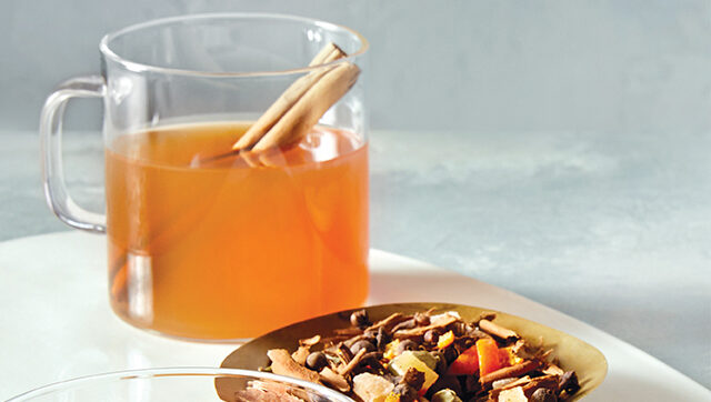 cozy tea toddy mocktail with cinnamon sticks