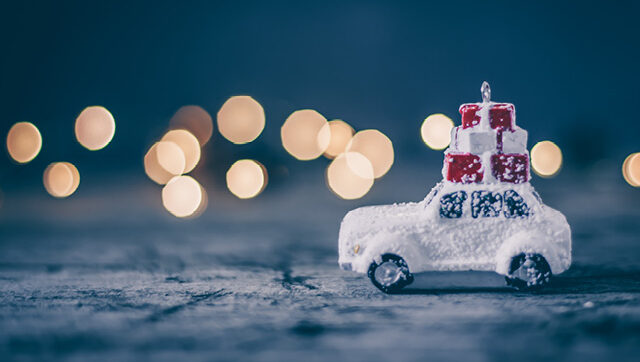 Christmas holiday concept with toy car and magic bokeh