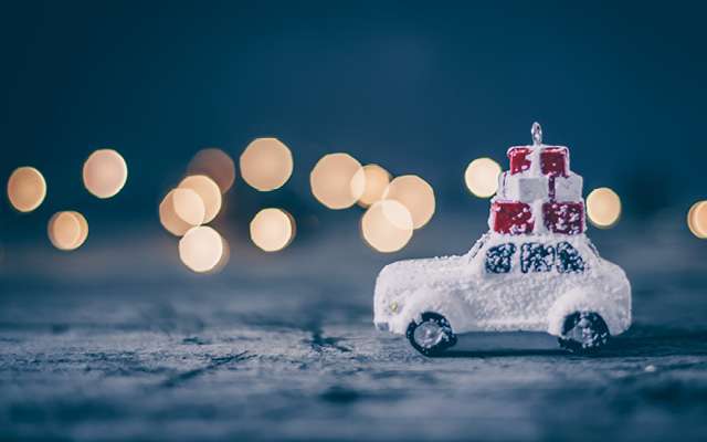 Christmas holiday concept with toy car and magic bokeh
