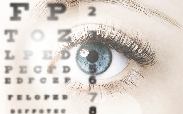 An eye superimposed with an eye chart