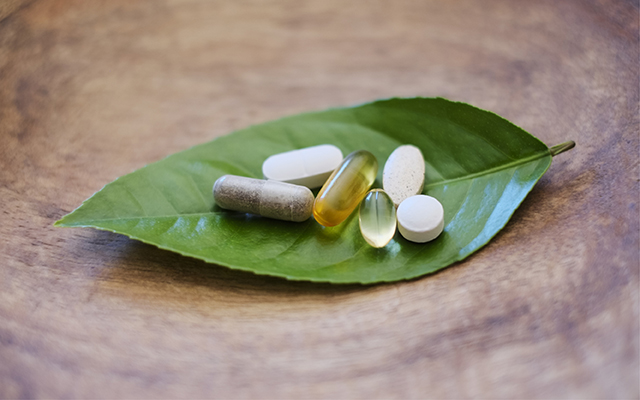 supplements sitting on a leaf