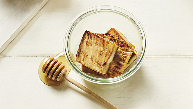 a glass bowl with Honey Tamari Roasted Tofu