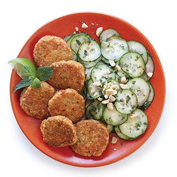 Thai fish cakes with cucumber salad on a red plate