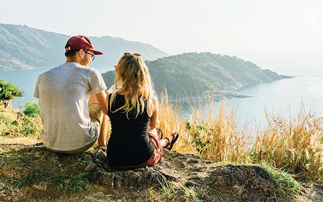 A couple talking atop a hill