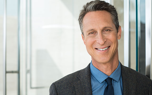 Mark Hyman smiles in his cover shot for Experience Life magazine.