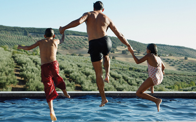 Family jumping into lake