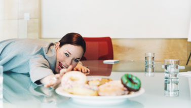 woman reaching for donut
