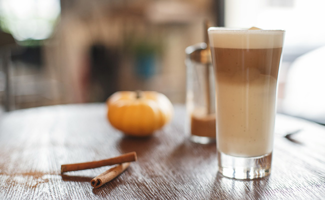 Pumpkin spice latte with cinnamon stick and pumpkin