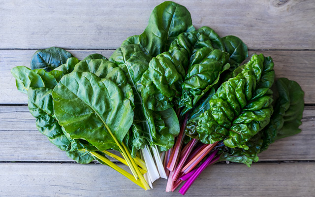 A bunch of Swiss chard on a table