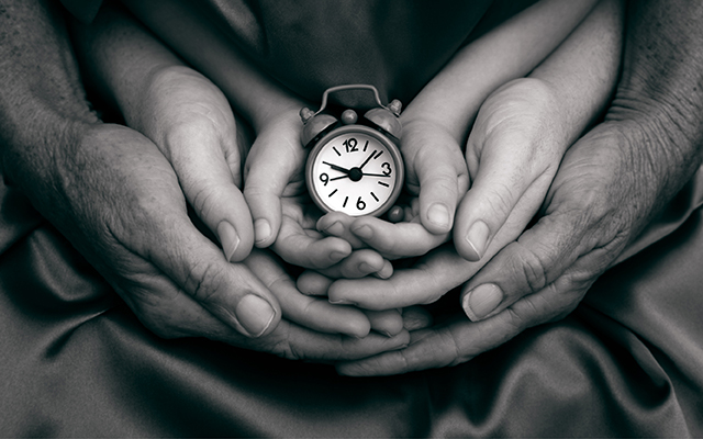 generational hands holding clock