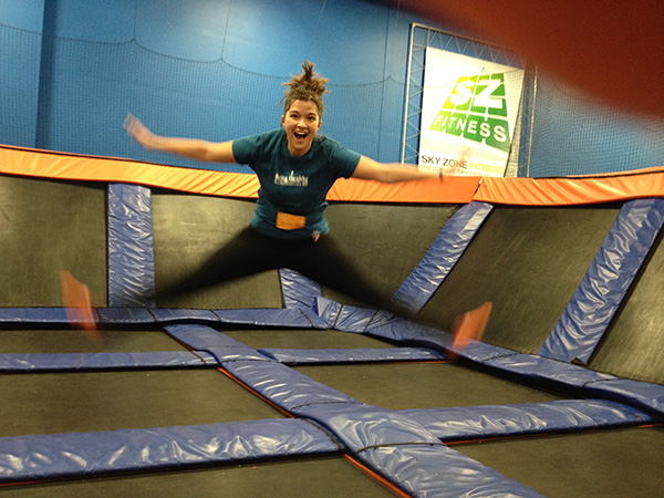 woman dropping at trampoline park