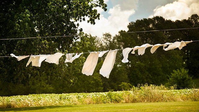 White linens drying outside on clothesline