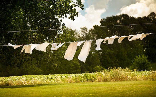 White linens drying outside on clothesline