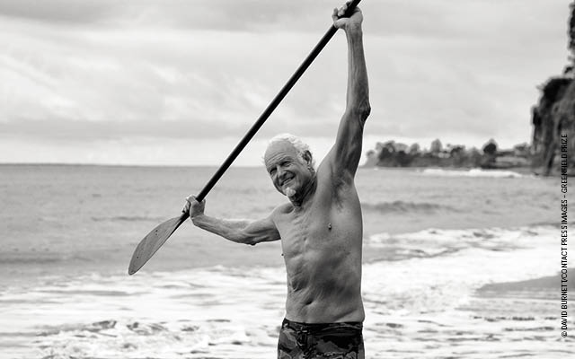 senior man oceanside with paddle