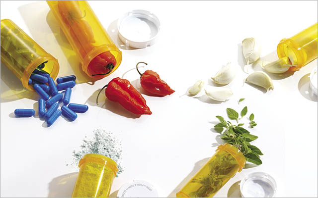 Chili peppers and herbs in pill bottles