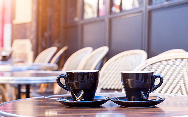 Two cups on an outdoor table