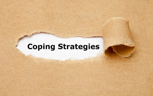 A piece of torn paper reveals the phrase "Coping Strategies"