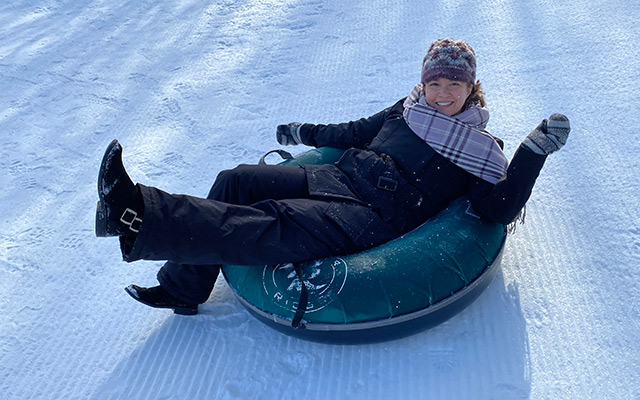 EL manager editor Courtney Lewis Opdahl is tubing in the snow.