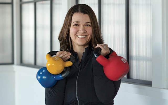 Courtney Opdahl holding three kettlebells