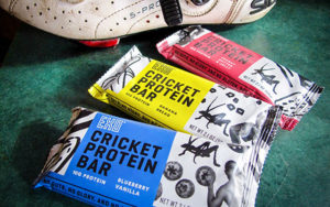 Cricket-protein bars are fanned out on a table.