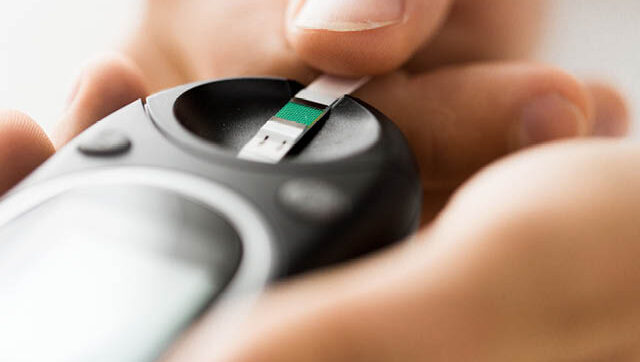 A person testing their blood sugar