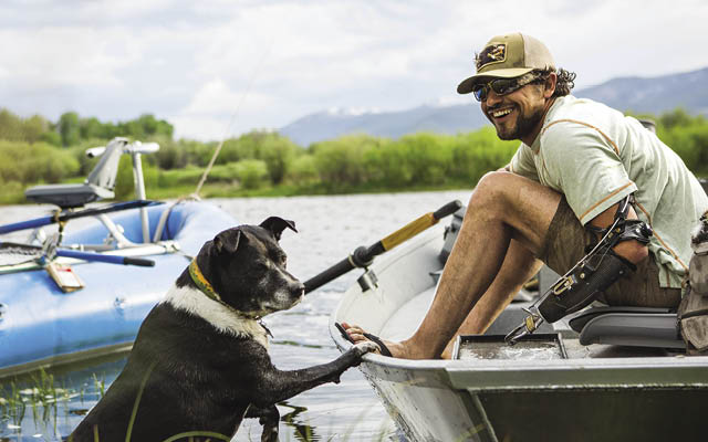 Eduardo Garcia in a boat with his dog