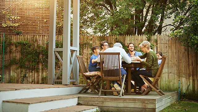 A happy family enjoys lunch together outside.