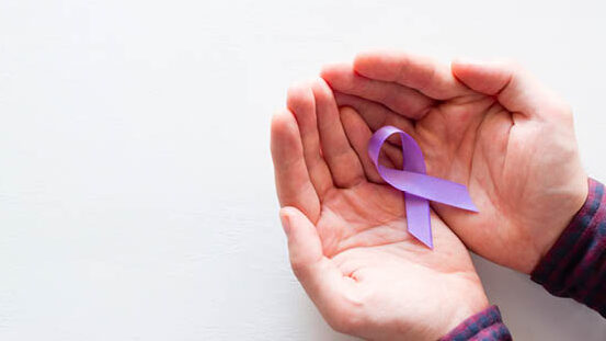 hands-hold-a-purple-ribbon