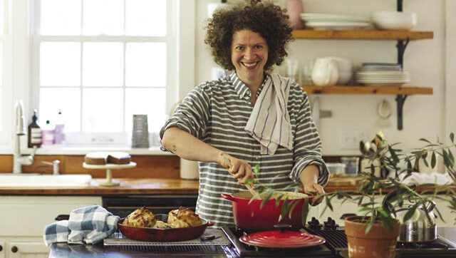 A photo of cookbook author Julia Turshen cooking in her kitchen