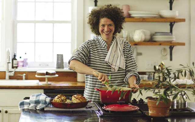 A photo of cookbook author Julia Turshen cooking in her kitchen
