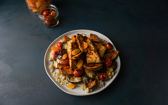 A bowl of cous cous and Moroccan-spiced tempeh